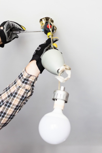 electrician removing fault ceiling lamp