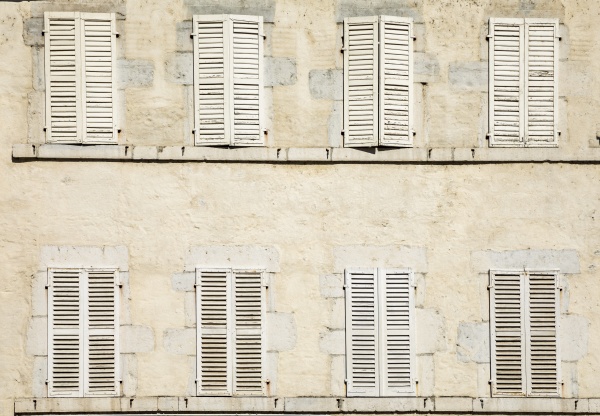 house facade with eight closed shutters