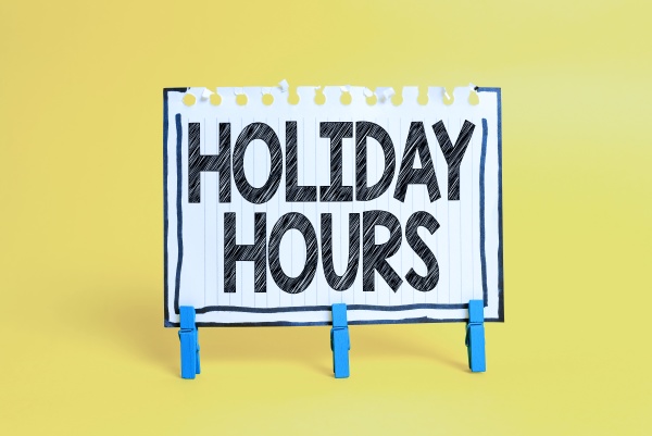 sign displaying holiday hours word