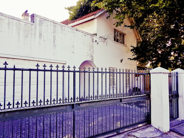 nostalgic old purple white building behind