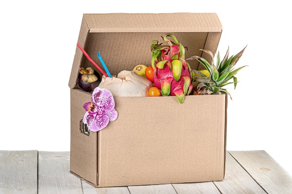 tropical fruits in cardboard box isolated