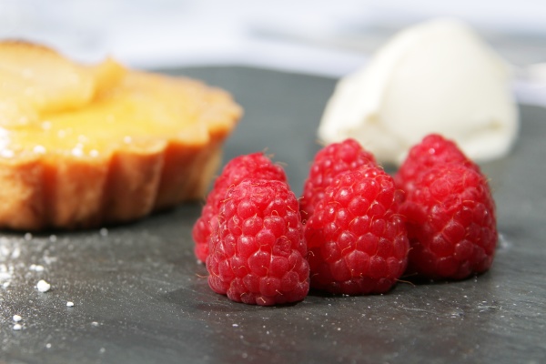 raspberries on a slate bed with