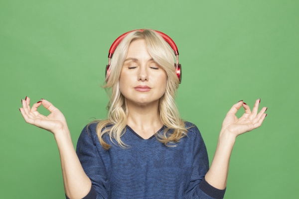 portrait serene woman meditating with headphones