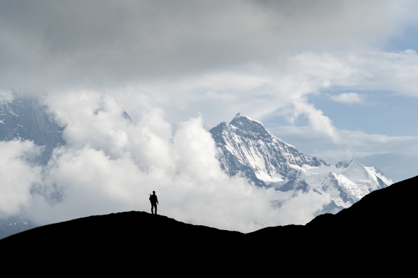 silhouette of hiker man admiring jungfrau