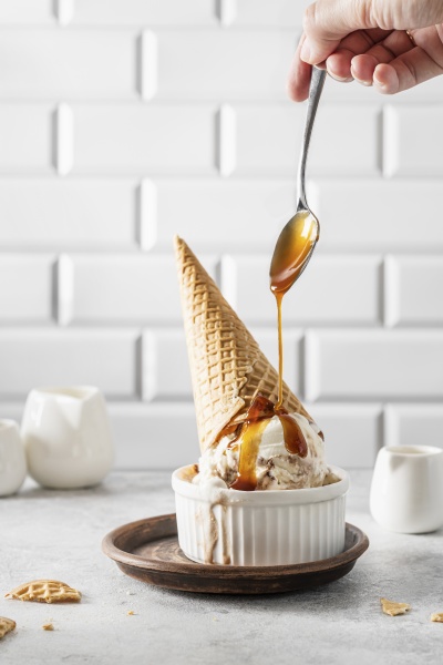 ice cream with pouring caramel sauce