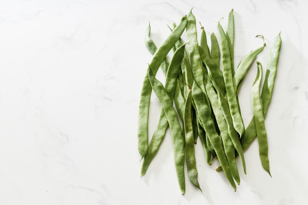 romano flat green beans on white