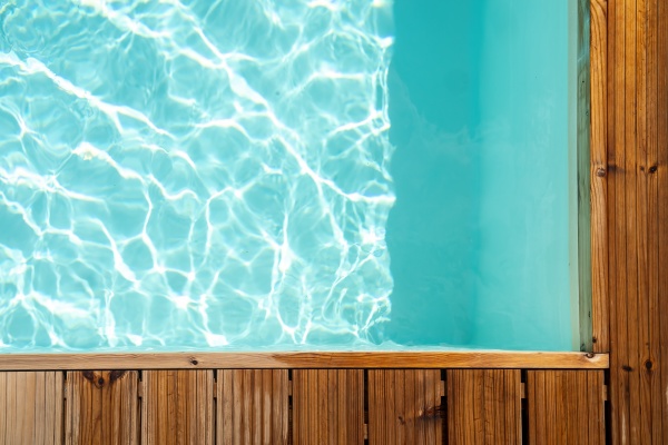 background with wooden board on swimming