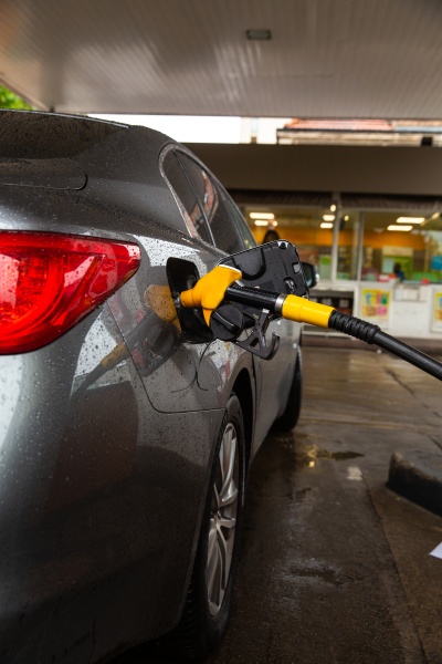 pumping gasoline fuel in car at