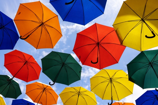 colorful umbrellas hanging against blue sky