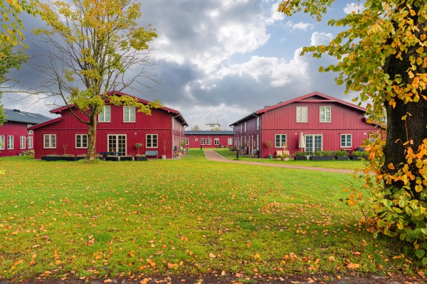several identical red wooden houses stand