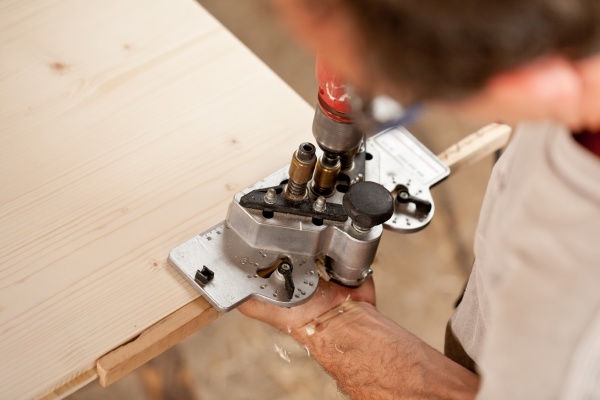 carpenter placing a jig and piercing