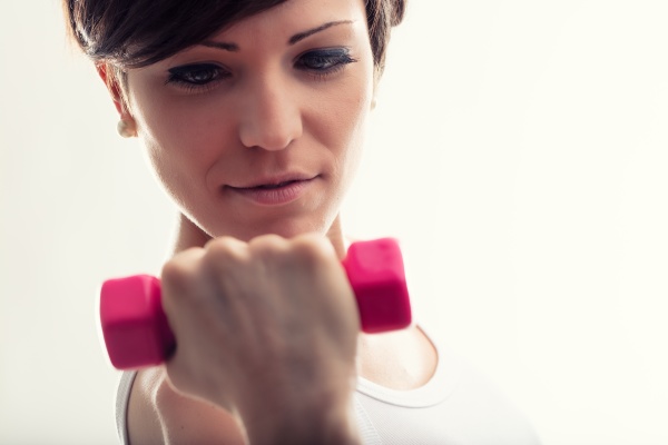 young woman working out with weights