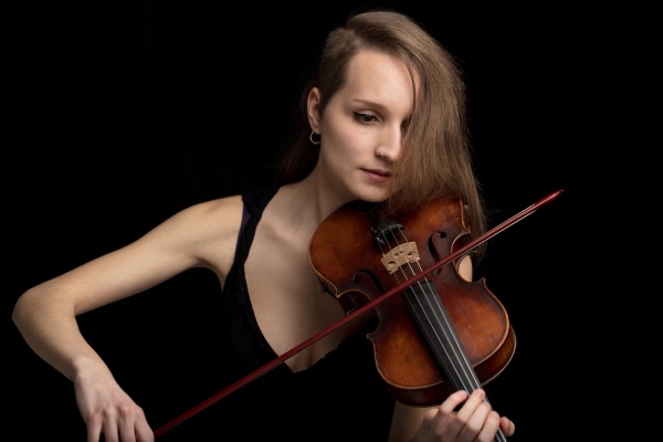 trendy modern female violinist playing in