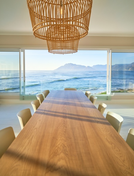 rattan pendant lights over wooden dining