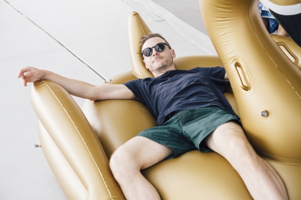 handsome man wearing sunglasses lying on