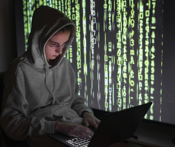 female computer hacker using laptop while