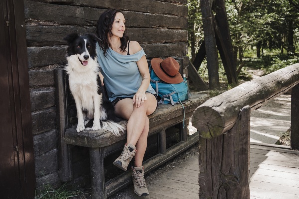 female tourist sitting with pet dog