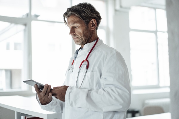 male healthcare worker using digital tablet