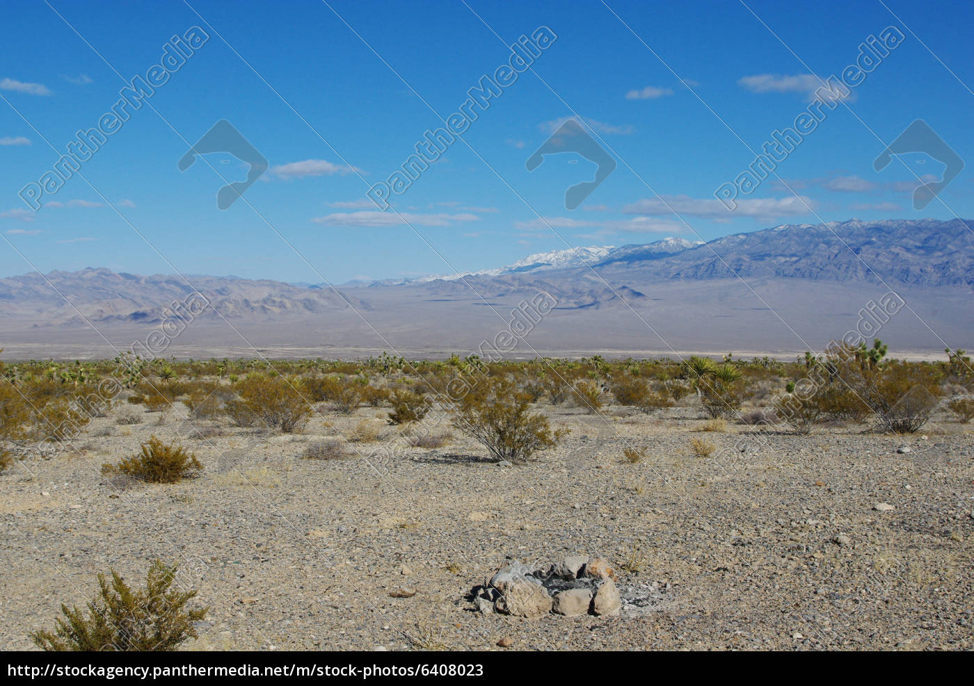 Fire Pit Vast Desert And High Snowy Mountain Range Stock Photo