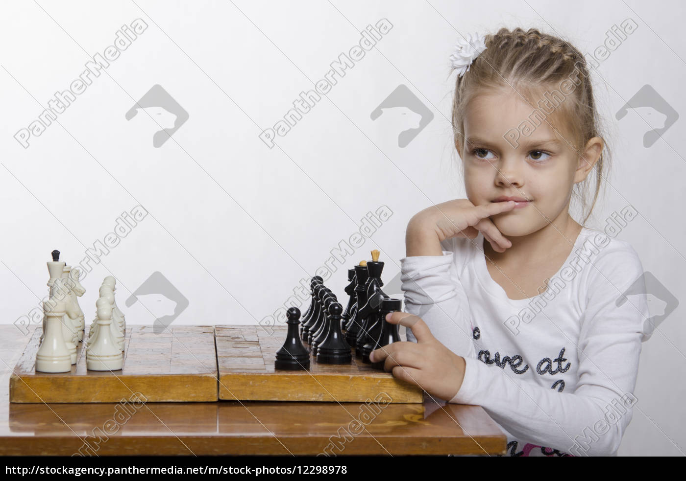 four-year-old-girl-with-a-sly-look-plays-chess-stock-image-12298978