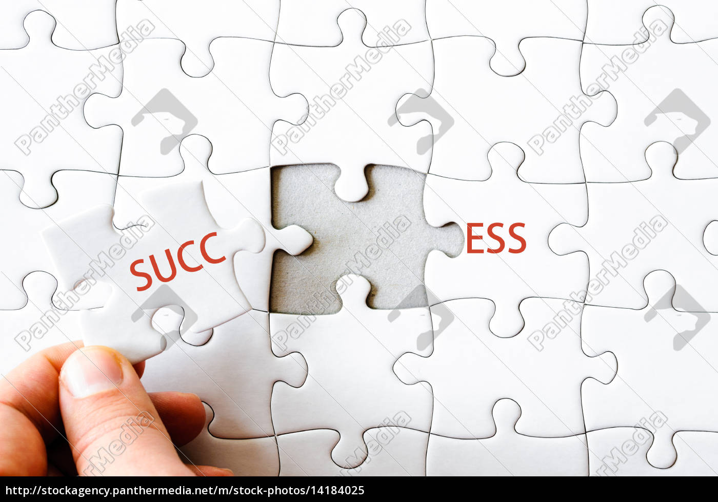 Missing jigsaw puzzle piece completing word SUCCESS - Stock Photo