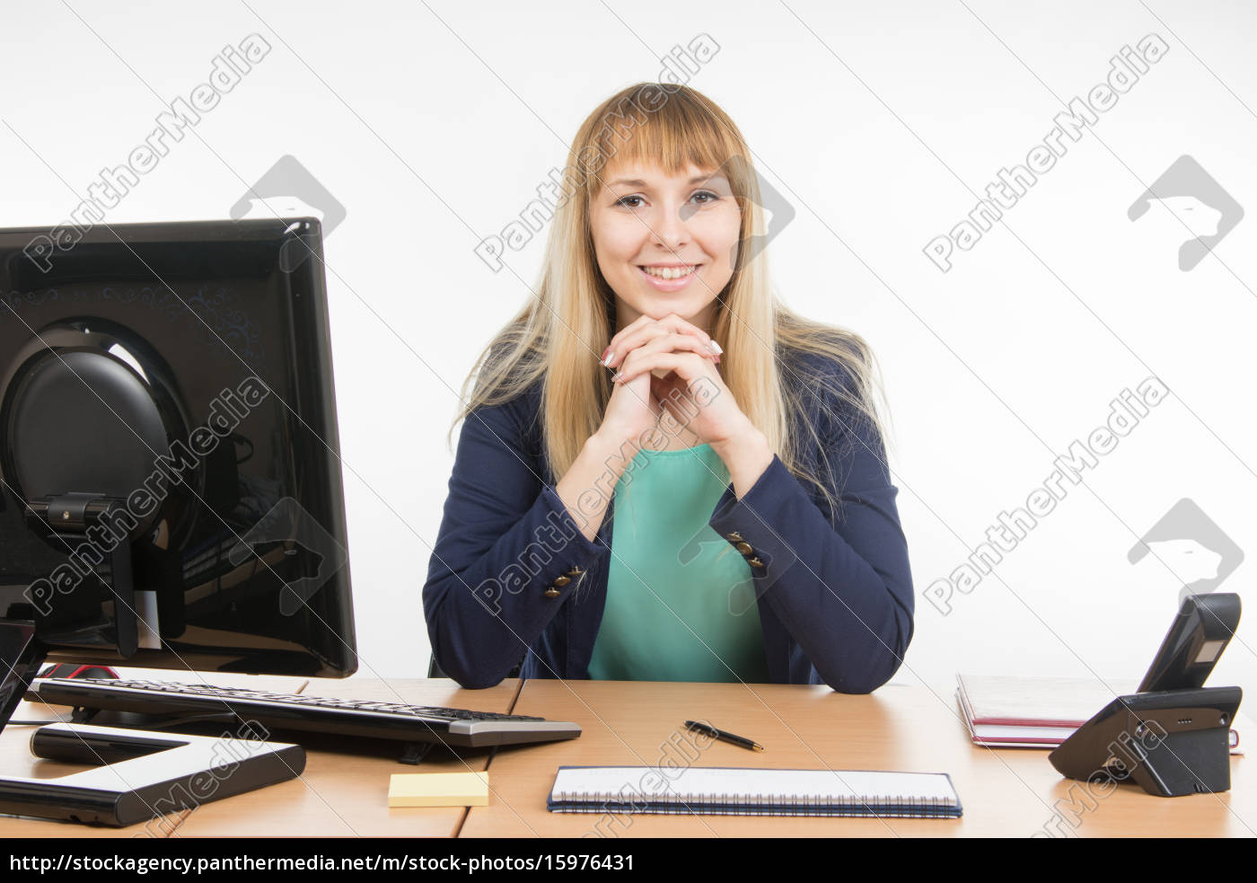 Happy Secretary Sitting Behind A Desk Royalty Free Image