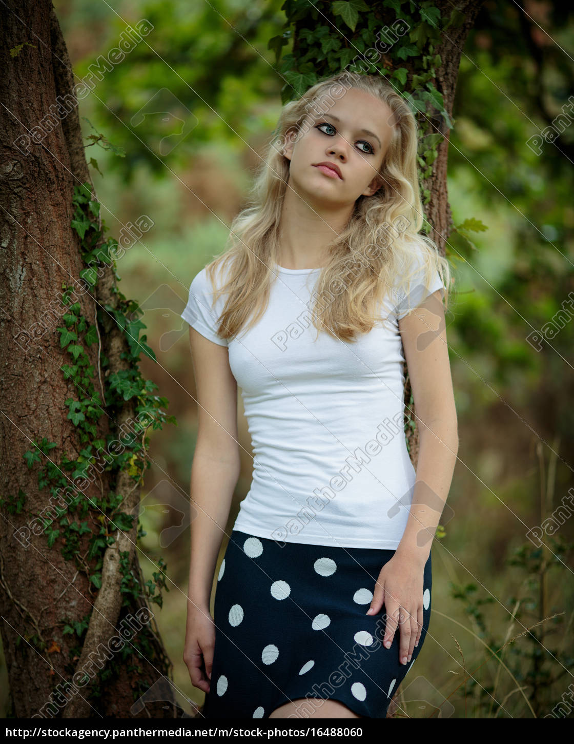 Beautiful Blond Teenage Girl Outside In The Woods