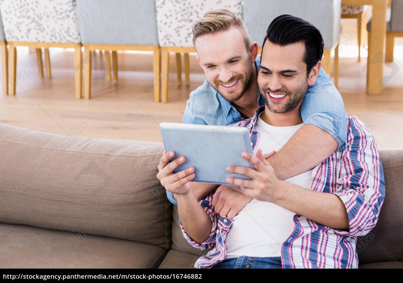 Gay couple relaxing on the couch using tablet - Royalty free image  #16746882 | PantherMedia Stock Agency