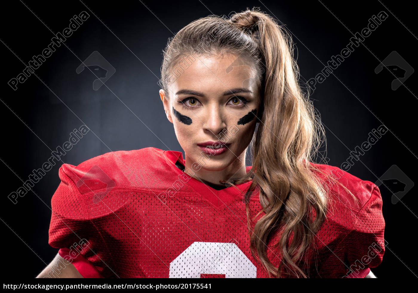 Female american football player in uniform, Stock image