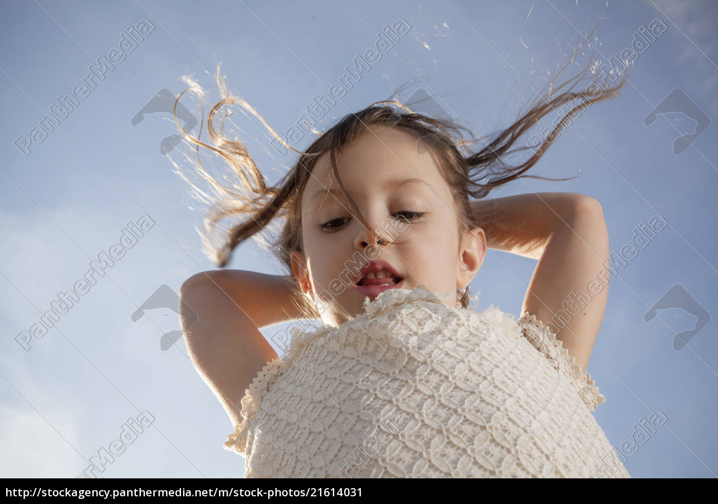 Low Angle Shot Of Young Girl Against Blue Sky Royalty Free Image