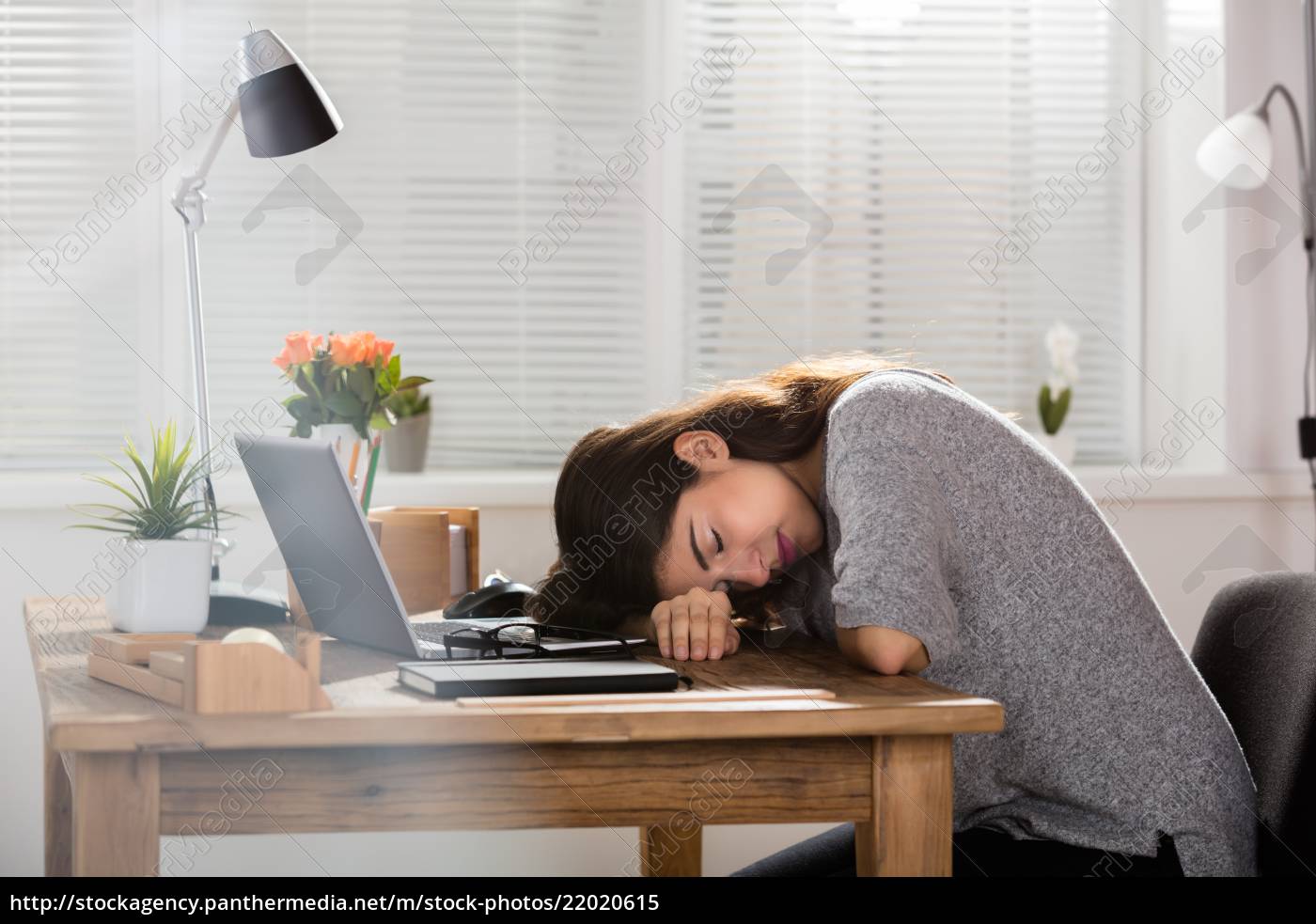 Young Businesswoman Sleeping On Office Desk Royalty Free Image