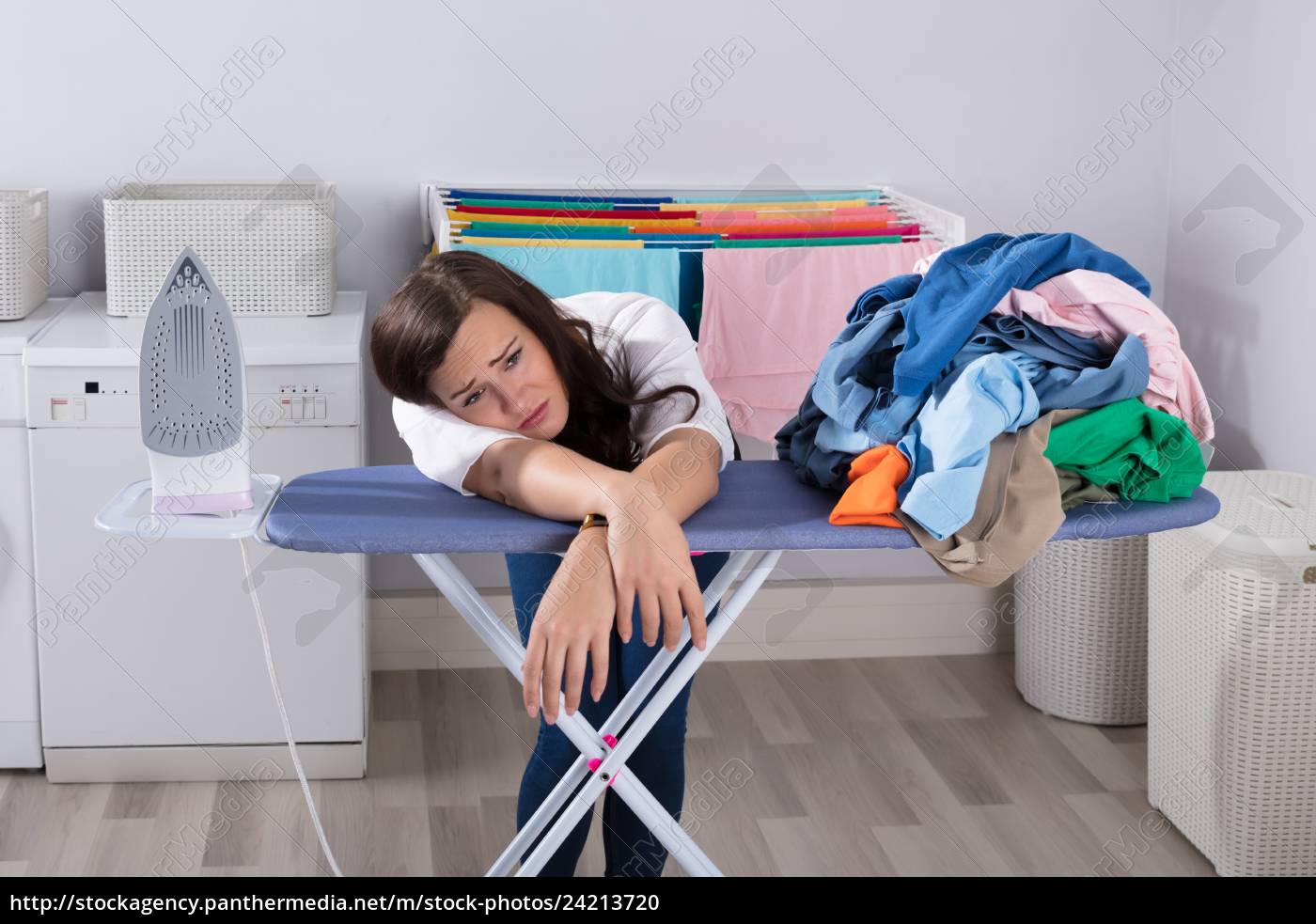 Unhappy Woman Leaning On Ironing Board Royalty Free Photo