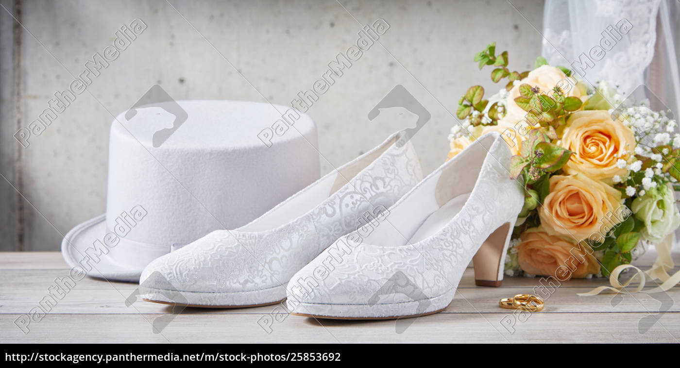 Wedding shoes next to flower bouquet 