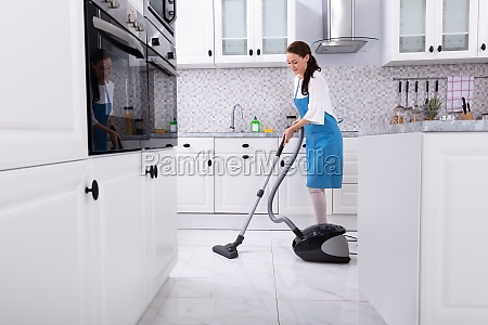 Janitor Cleaning Kitchen Floor With Vacuum Floor Royalty Free Image 26161827 Panthermedia Stock Agency