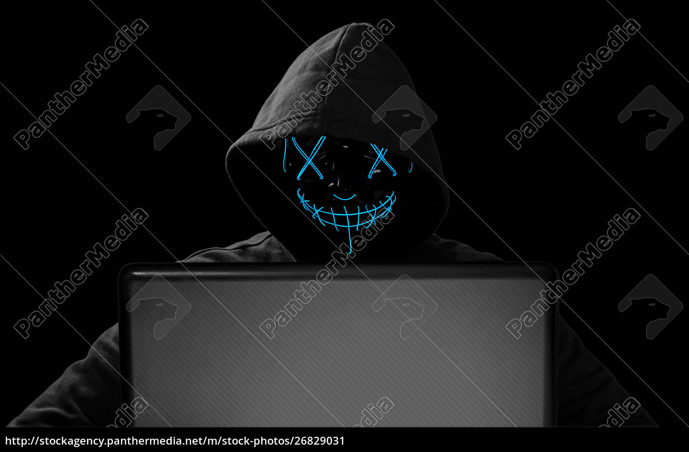 ~hacker with glowing mask behind notebook 26829031 high
